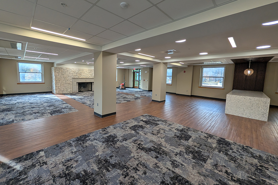 An interior shot shows a newly renovated college residence hall's lobby.