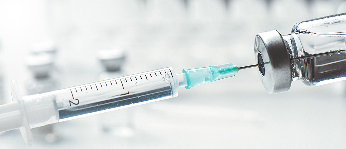 A close-up photo shows a syringe extracting clear liquid from a vial.