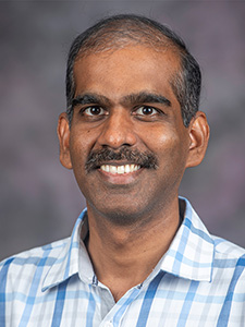 Prasad Parchuri smiles for a portrait.