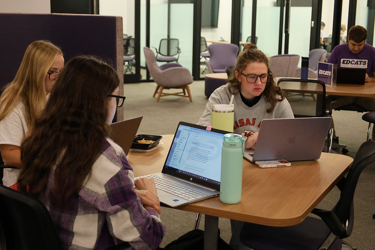 College students study at tables in a renovated college collaboration area.