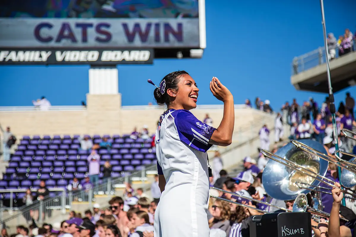 Olivia Franco directing the band during the football game.