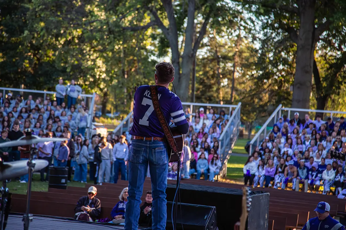 Gage Gardiner performing on stage afront of a crowd.